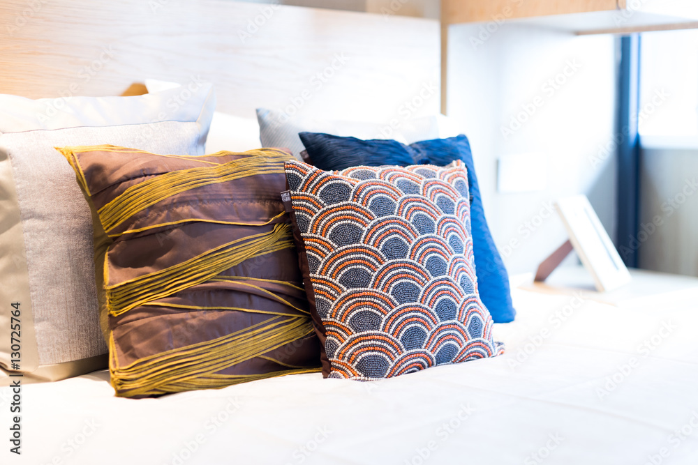 pillows on comfortable bed in modern bedroom