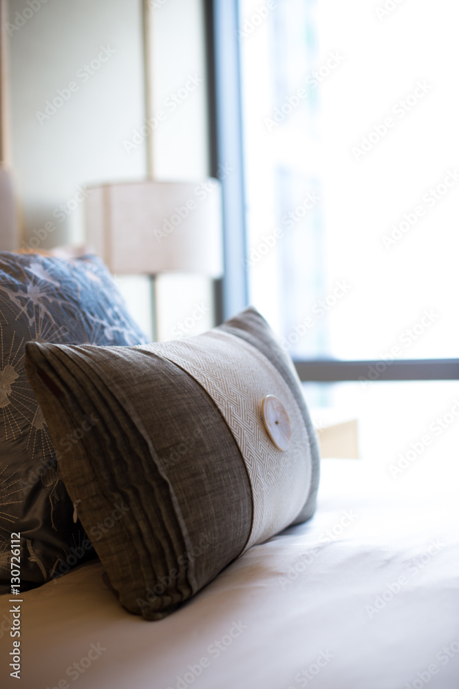 pillows on comfortable bed in modern bedroom