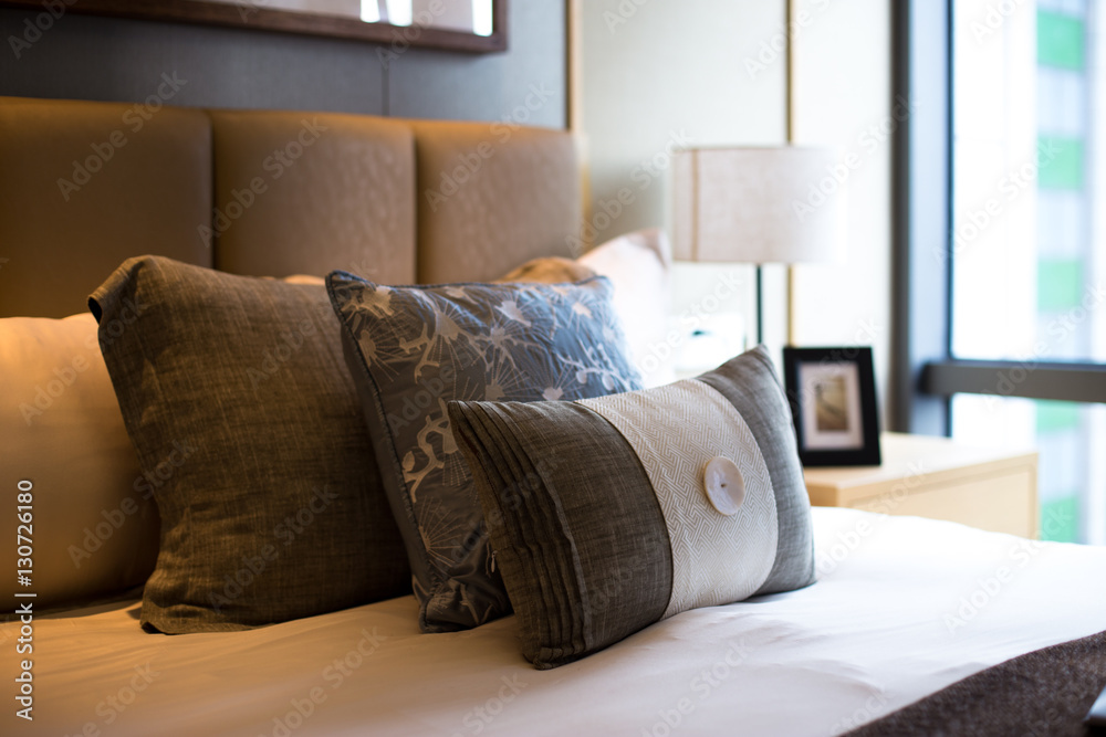 pillows on comfortable bed in modern bedroom