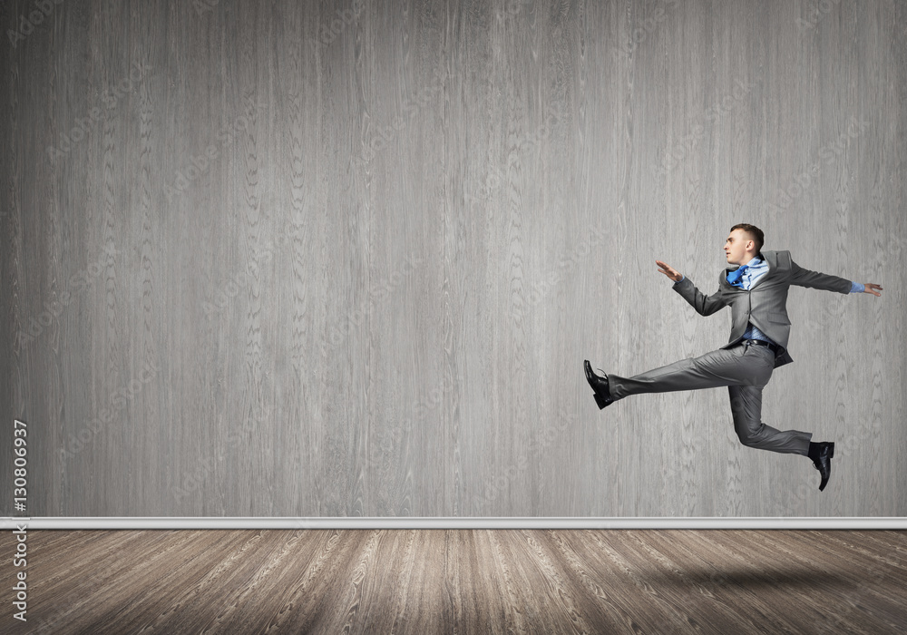 Businessman jumping high