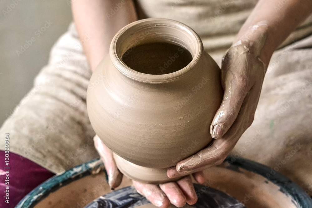 Potter holds more crude to the firing of white clay jug. Sculptor sculpts pots products from white c