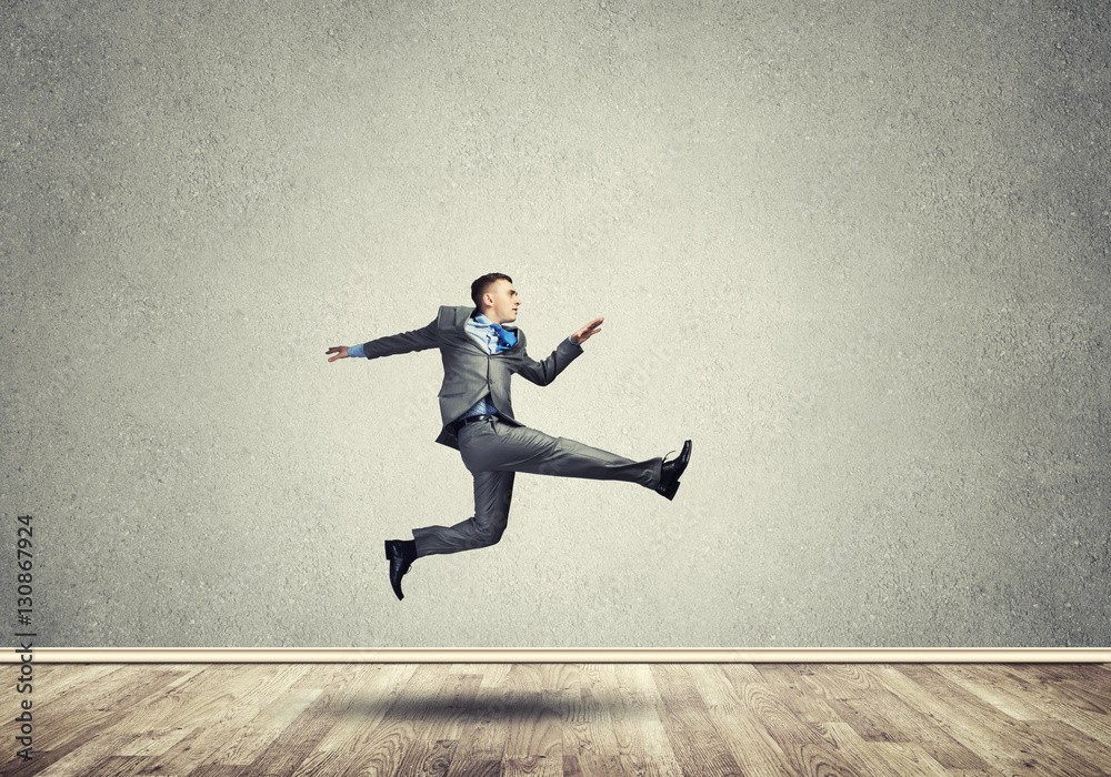 Businessman jumping high