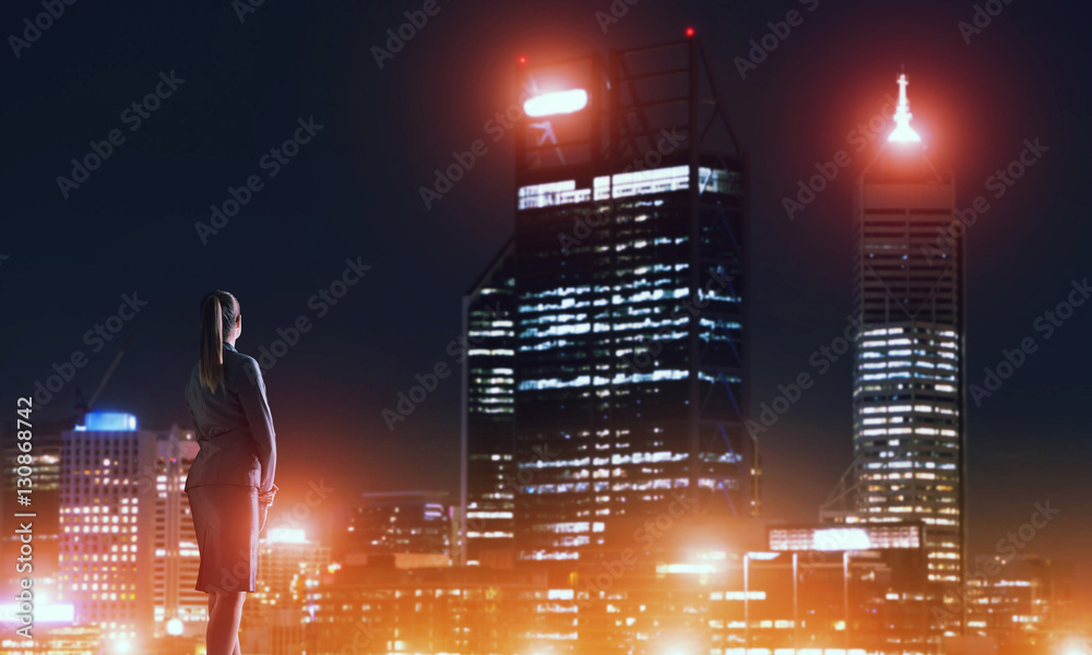 Woman looking at night city