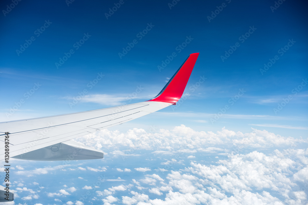 airplane wing above the clouds