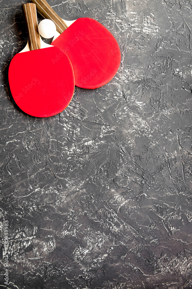 Red racket for ping pong ball gray background top view