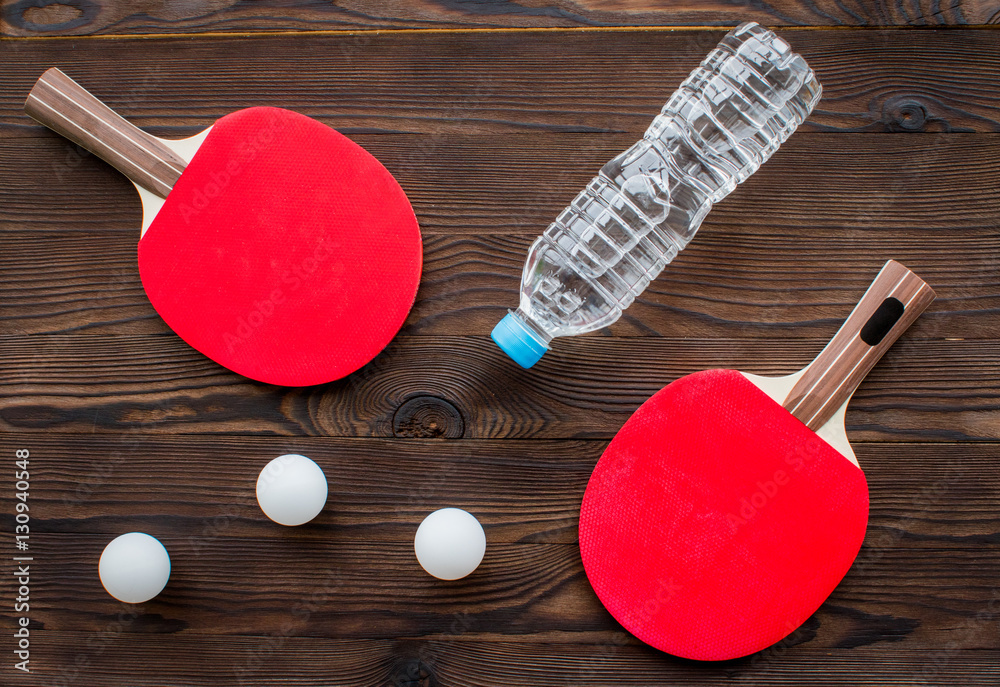 tennis racquet - fitness in the wooden background top view