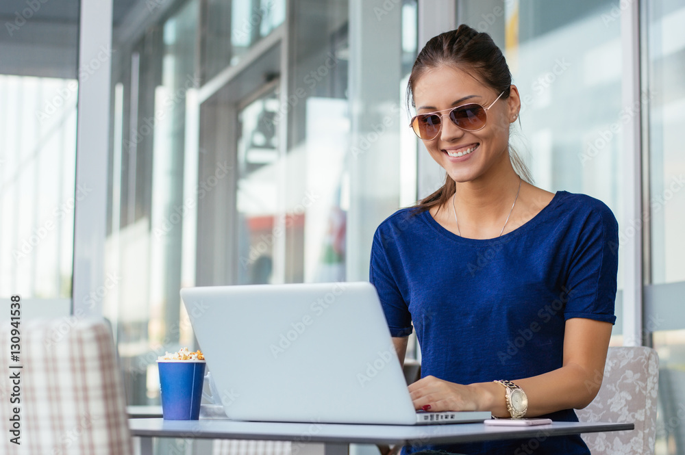 Young woman using laptop computer. Beautiful girl working on lap