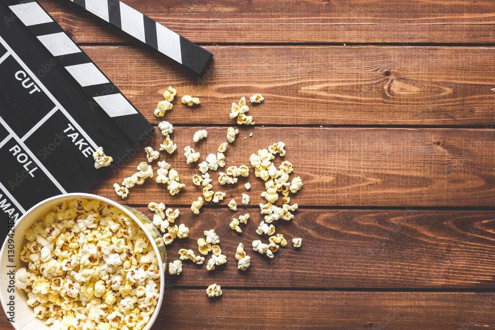 watching movie with popcorn on wooden background top view