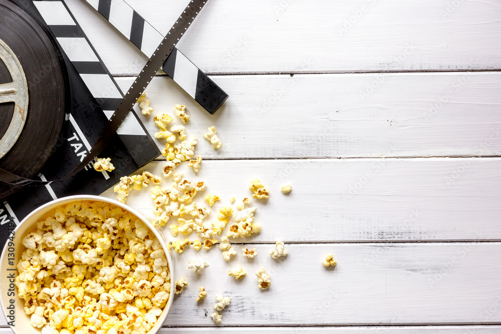 watching movie with popcorn on wooden background top view