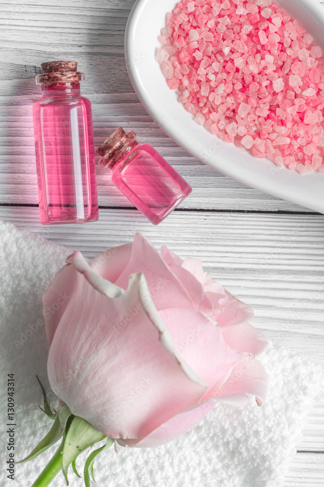 organic cosmetic with rose oil on wooden background top view