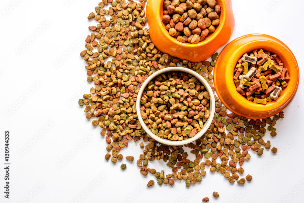 dry cat food in bowl on white background top view