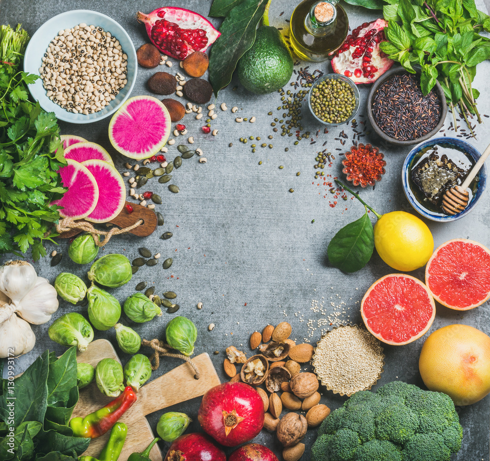 Clean eating concept over grey concrete background, top view, copy space. Variety of vegetables, fru