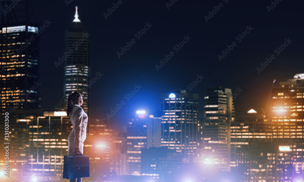 Woman looking at night city