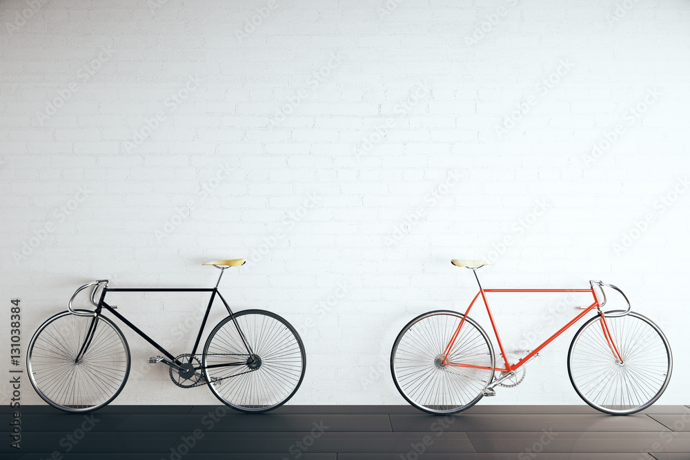 Two bikes in brick room