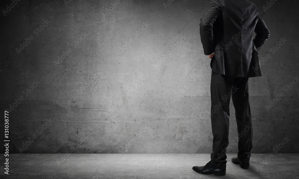 Businessman looking at wall