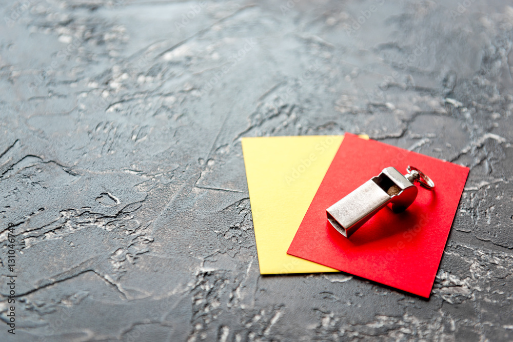 red and yellow cards on dark background close up