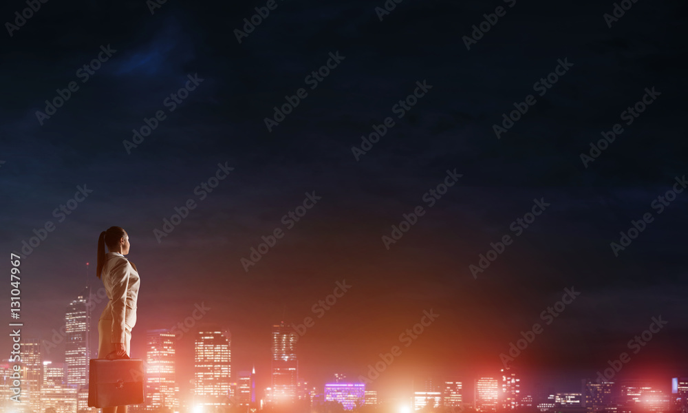 Woman looking at night city