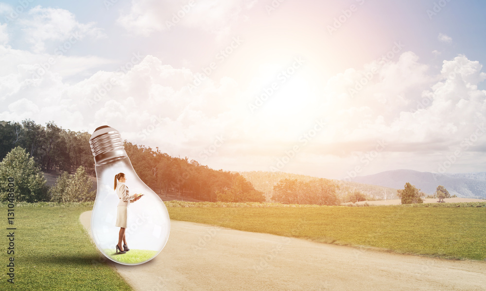 Businesswoman inside light bulb