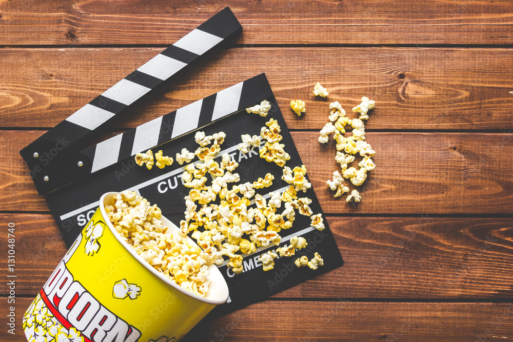 watching movie with popcorn on wooden background top view