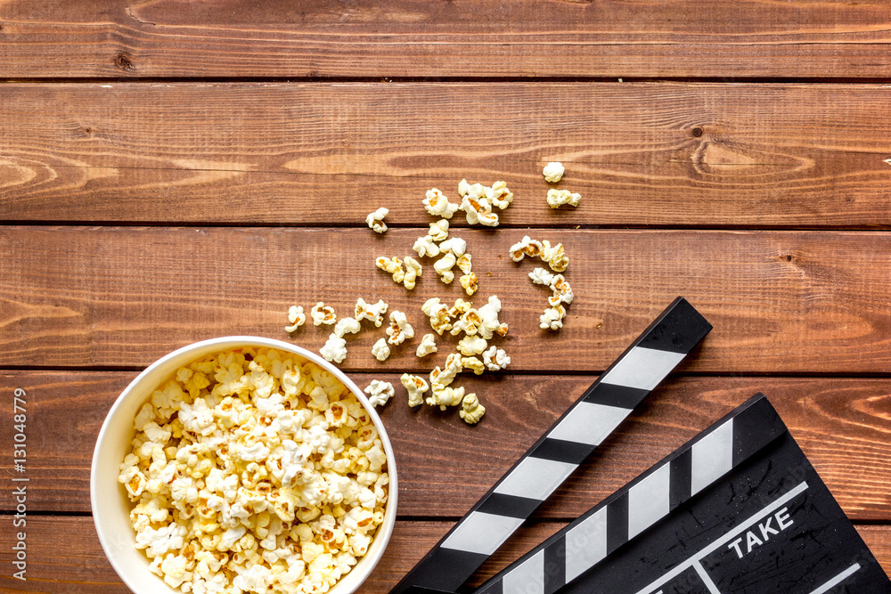 watching movie with popcorn on wooden background top view