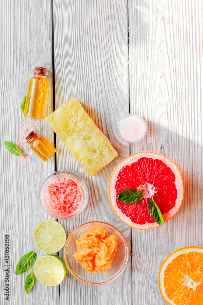 organic cosmetic with citrus on wooden background top view