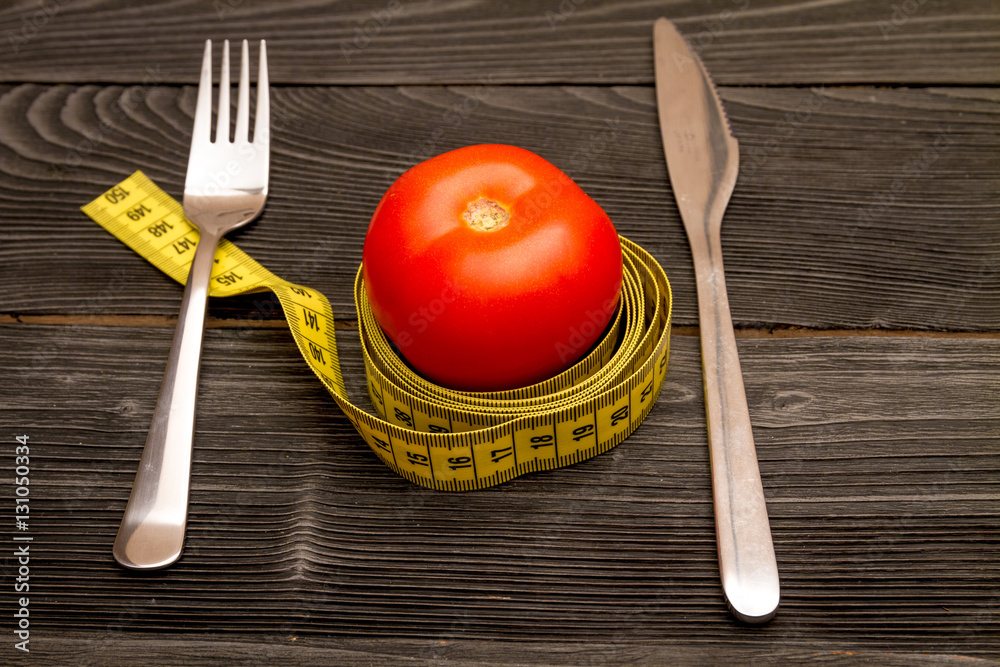 concept slimming diet fresh vegetables on wooden background