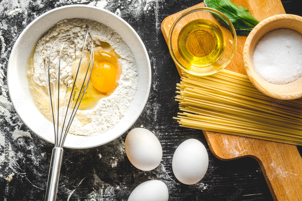 cooking process of pasta on dark background top view