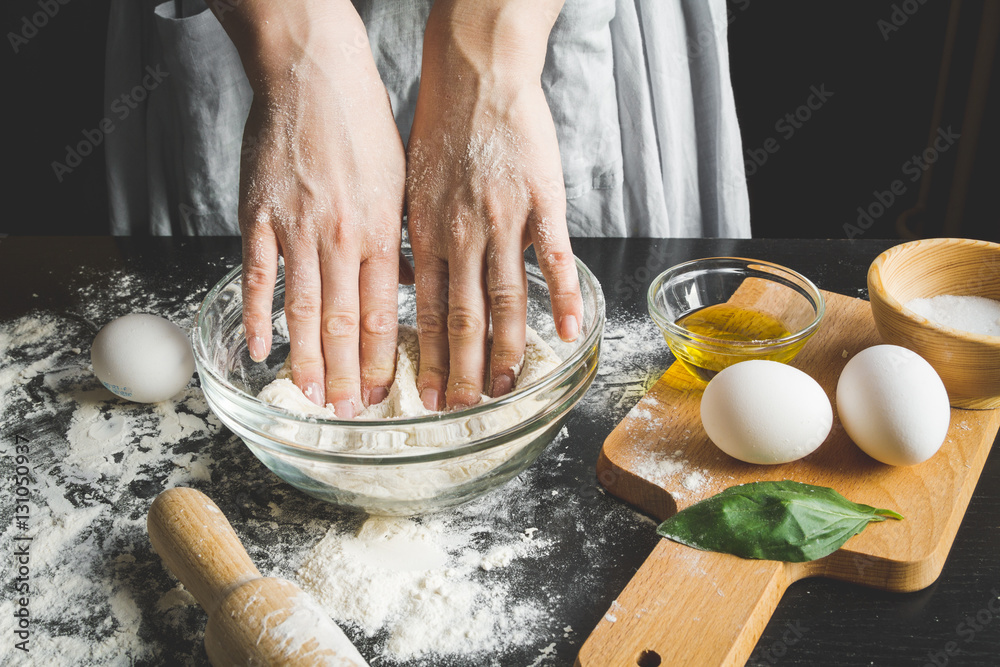 cooking pasta by chef in kitchen on dark background