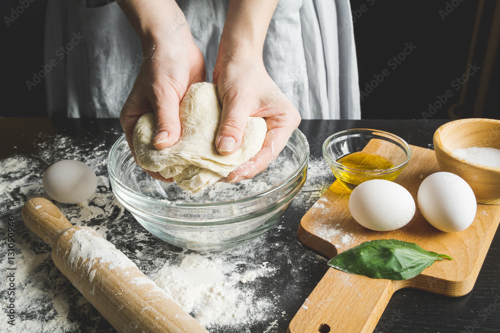 cooking pasta by chef in kitchen on dark background