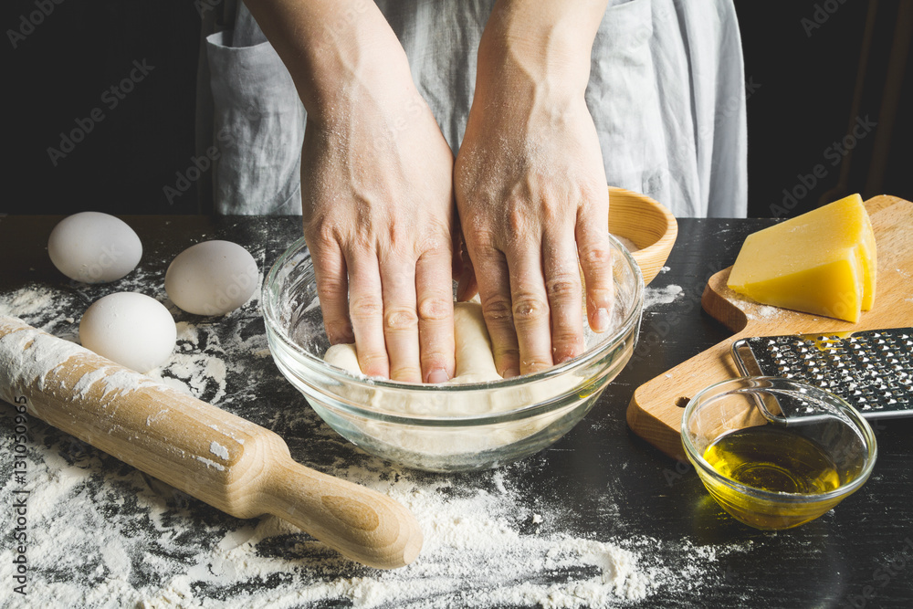 cooking pasta by chef in kitchen on dark background