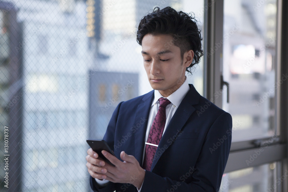 Young businessmen use smartphones