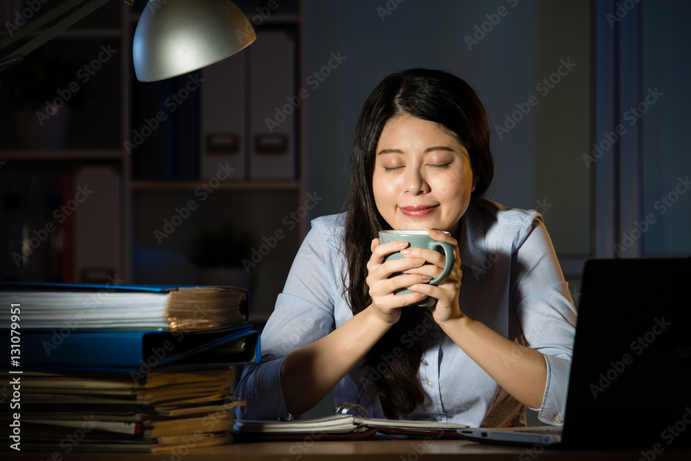 asian business woman drink coffee working overtime late night