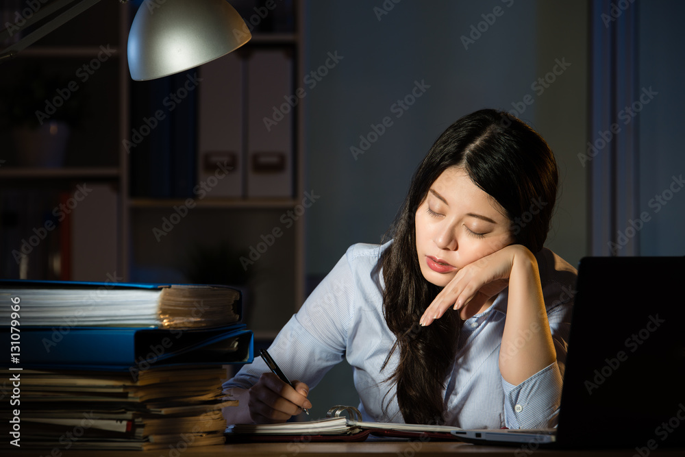 asian business woman sleepy working overtime late night