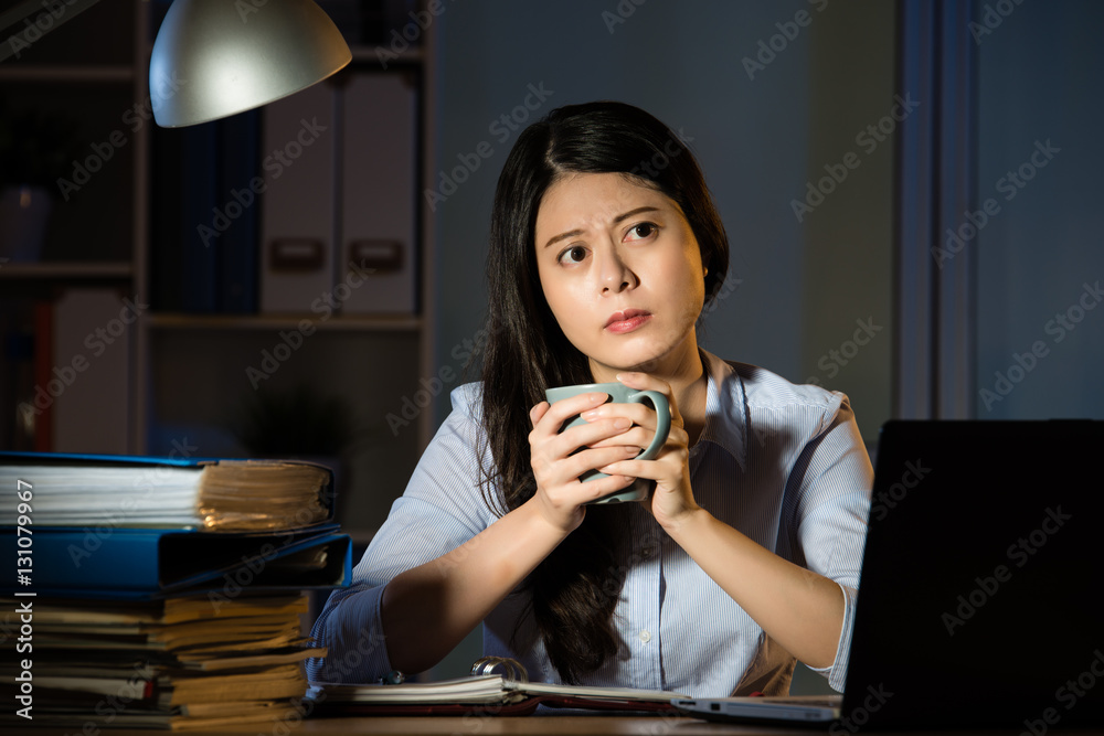 asian business woman drink coffee working overtime late night