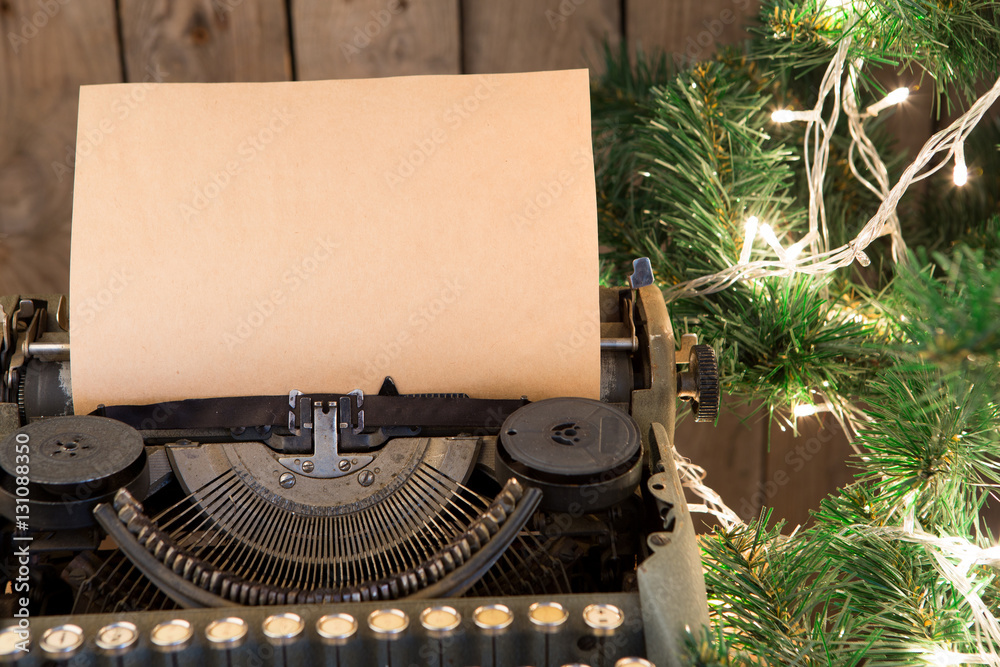 Christmas concept - Typewriter with the blank paper and lights