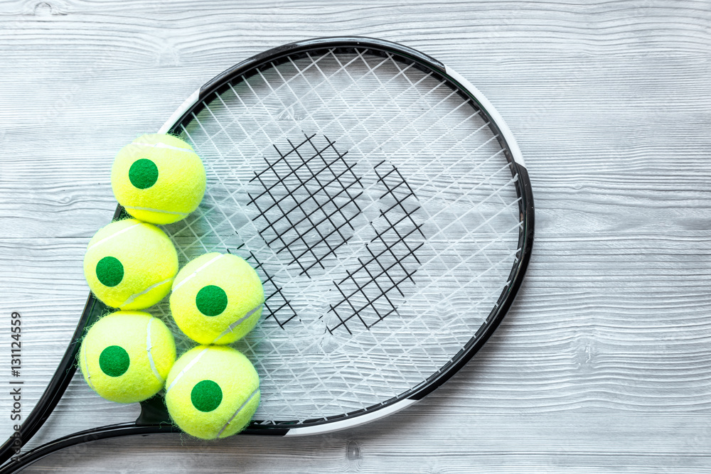 tennis racket on wooden background top view