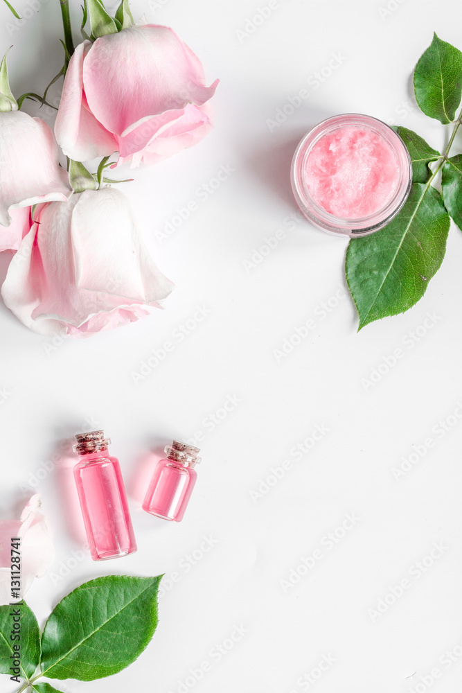 organic cosmetic with rose oil on white background top view