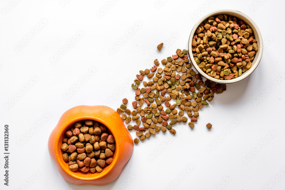 dry pet food in bowl on white background top view