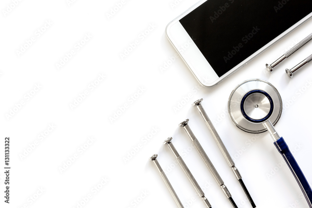 diagnostic of gadgets on white background with stethoscope top view