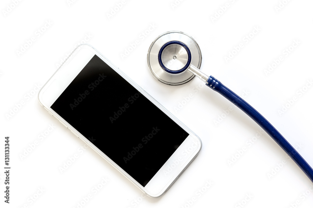 diagnostic of gadgets on white background with stethoscope top view