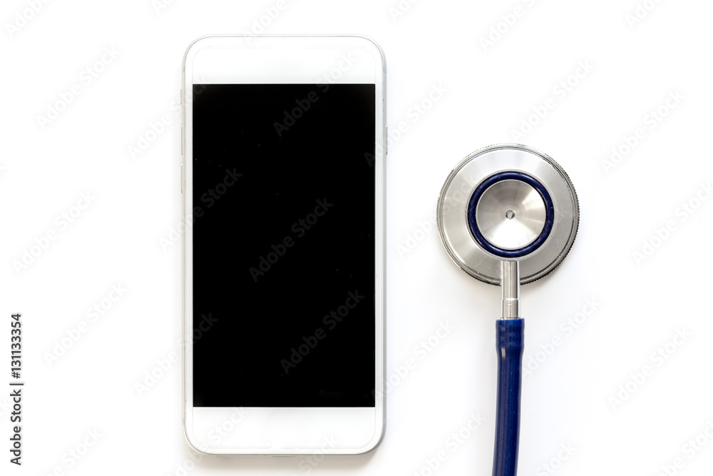 diagnostic of gadgets on white background with stethoscope top view