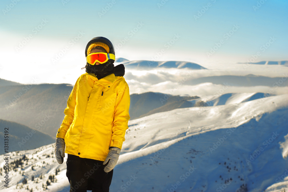 girl in snowboard equipment against the backdrop of snow-capped