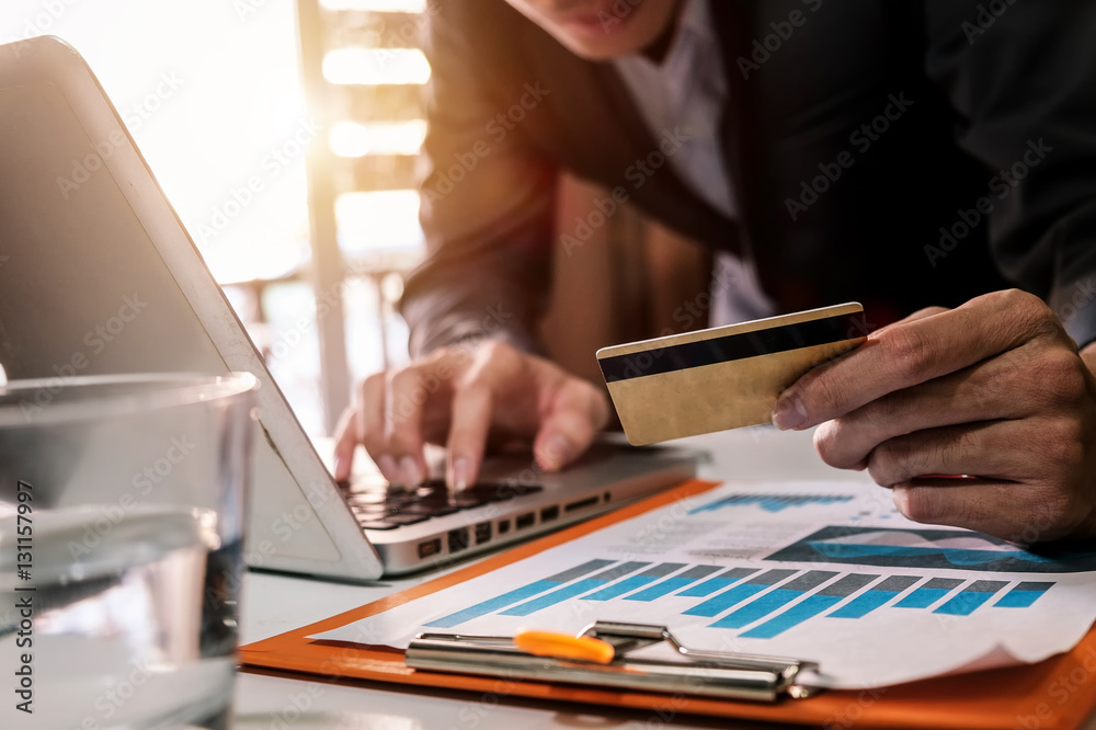 Man hands using laptop and holding credit card with social media as Online shopping concept in morni