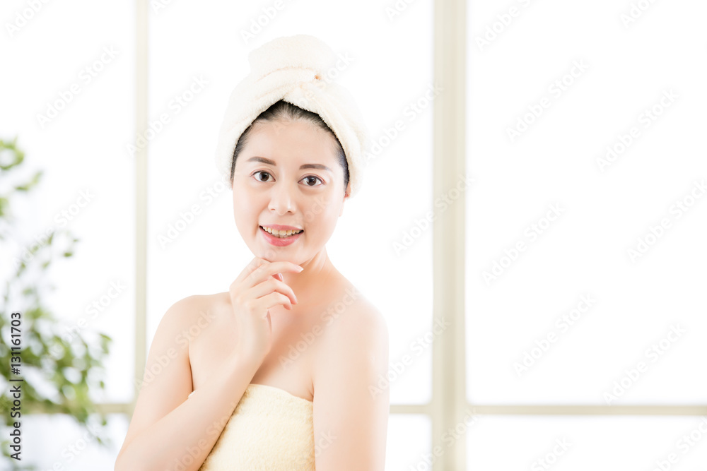 charming asian woman drying towel on head after shower