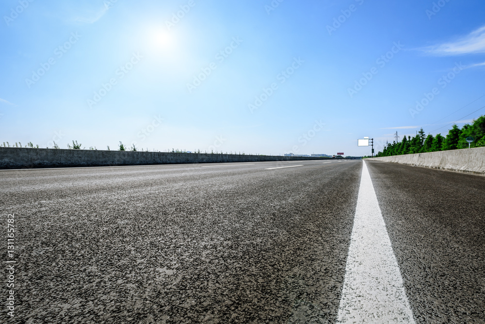 Asphalt road under the blue sky