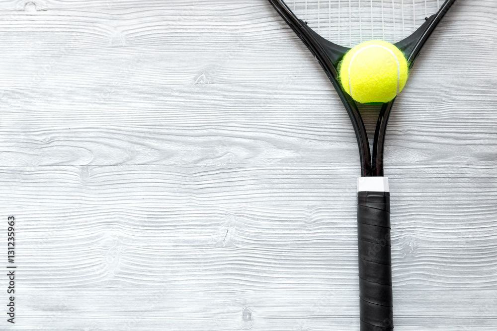 tennis racket on wooden background top view