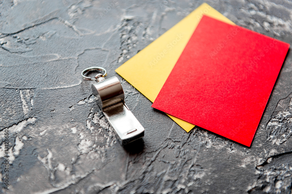 red and yellow cards on dark background close up