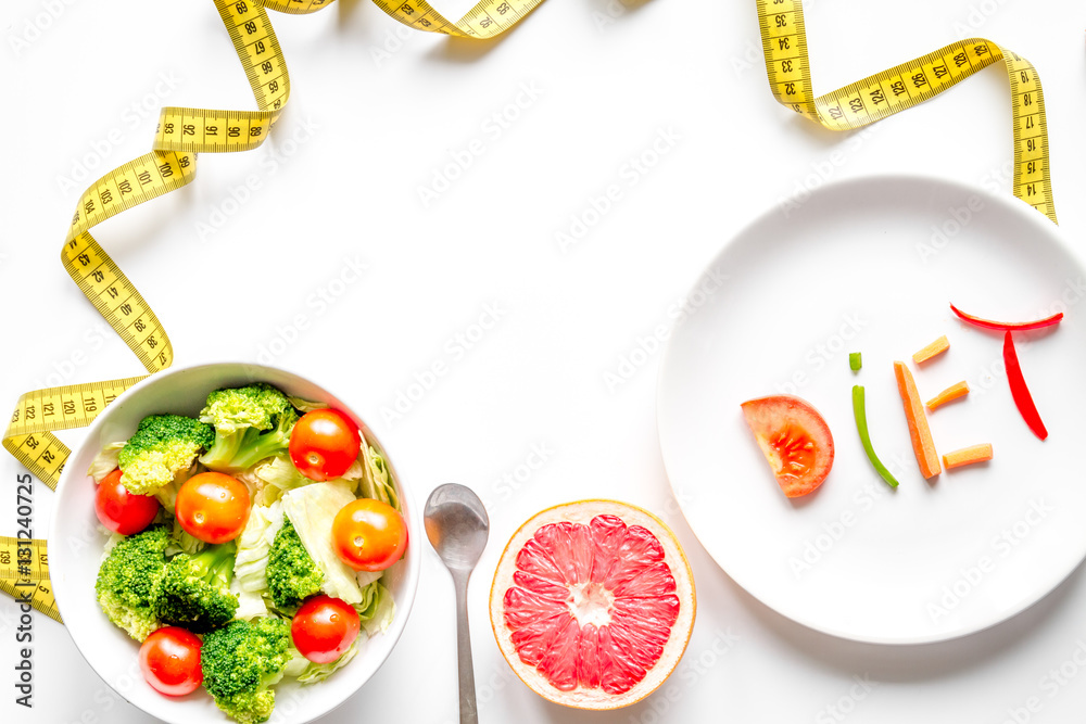 concept slimming diet fresh vegetables on white background top view