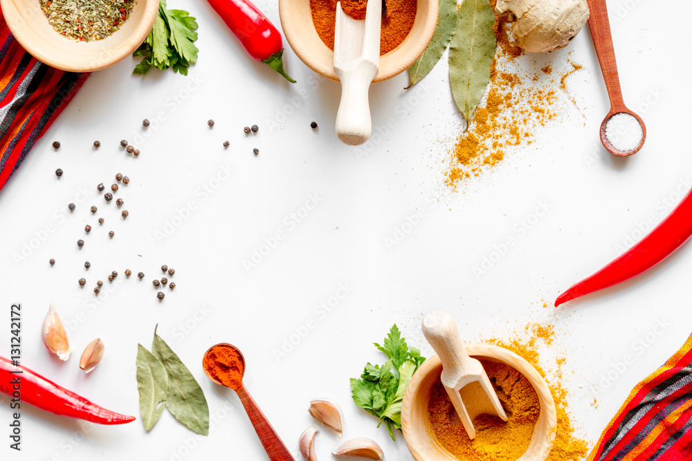 spices in wooden bowl white background top view