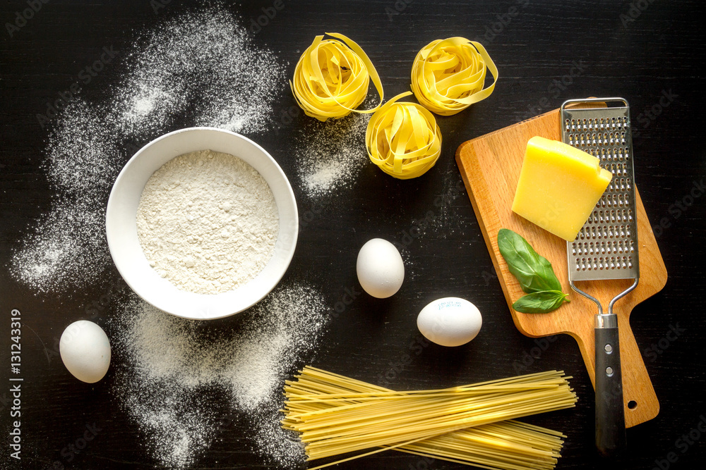 cooking process of pasta on dark background top view